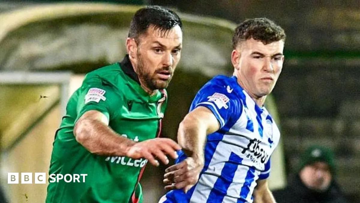 Two football players competing for possession of the ball Two football players competing for possession of the ball