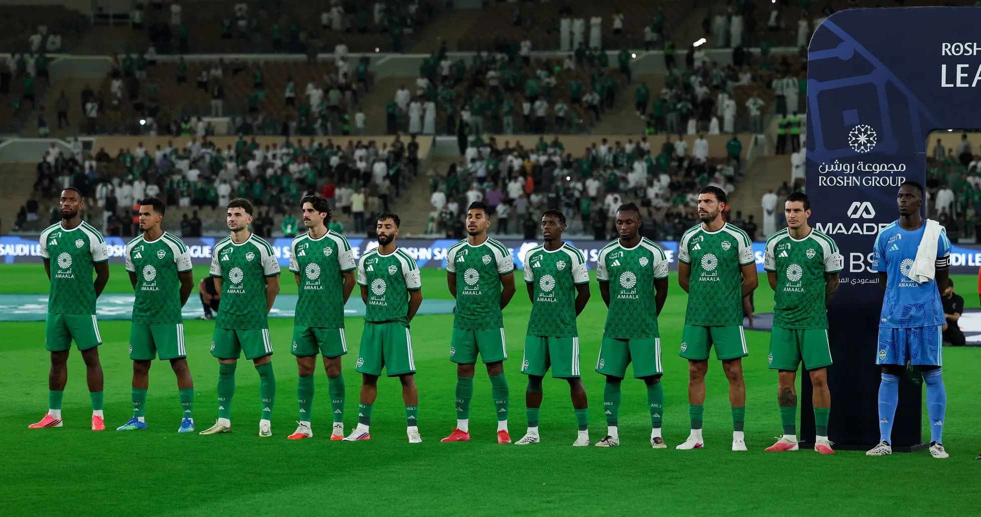 Football team lined up before match in green uniforms Football team lined up before match in green uniforms