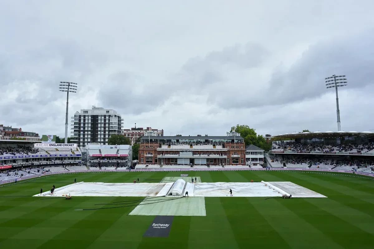 Ground staff covering pitch with tarp at Lord's Ground staff covering pitch with tarp at Lord's