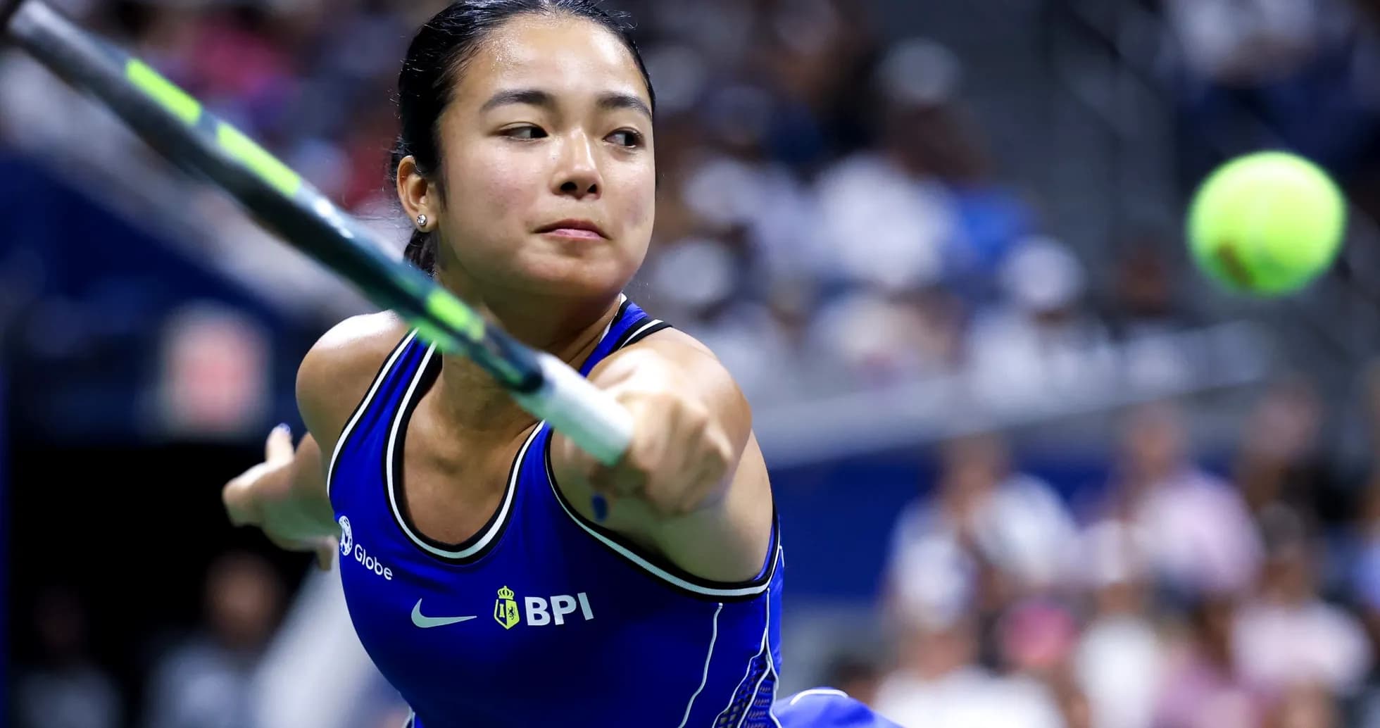 Tennis player hitting a ball during a match Tennis player hitting a ball during a match