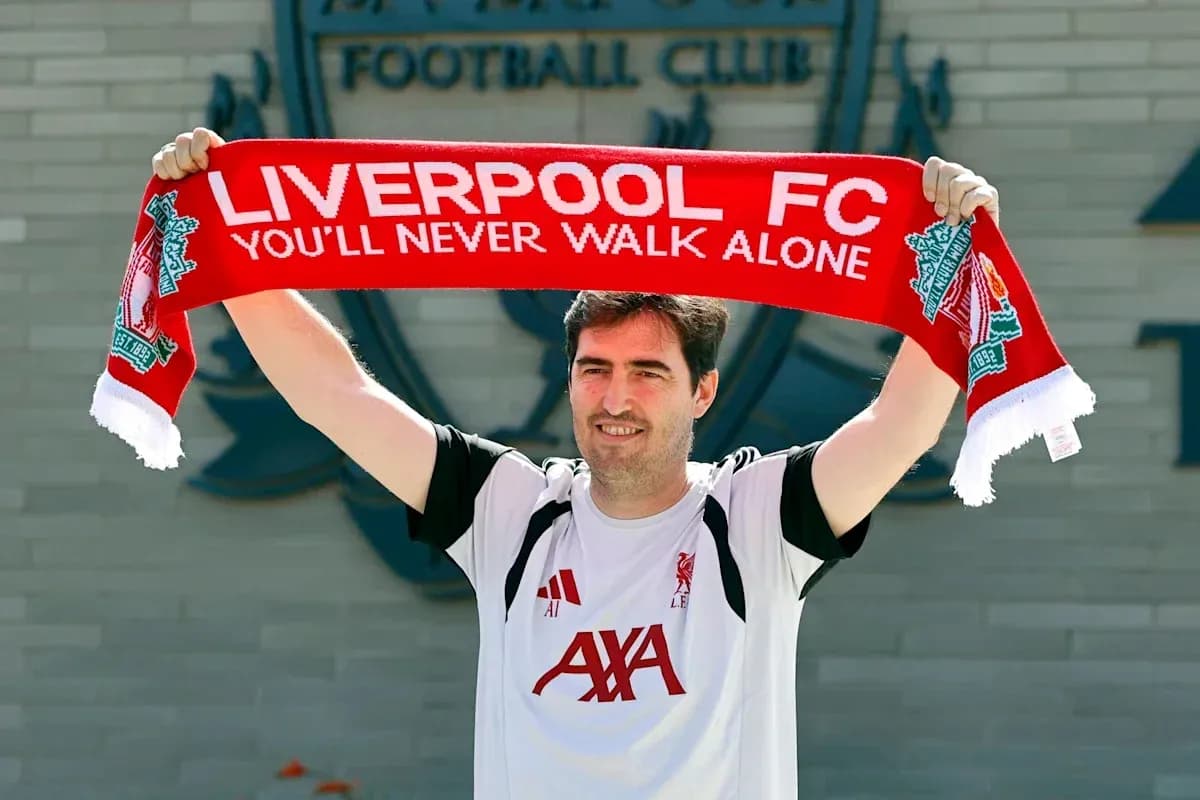 New coach holding Liverpool FC scarf during announcement New coach holding Liverpool FC scarf during announcement