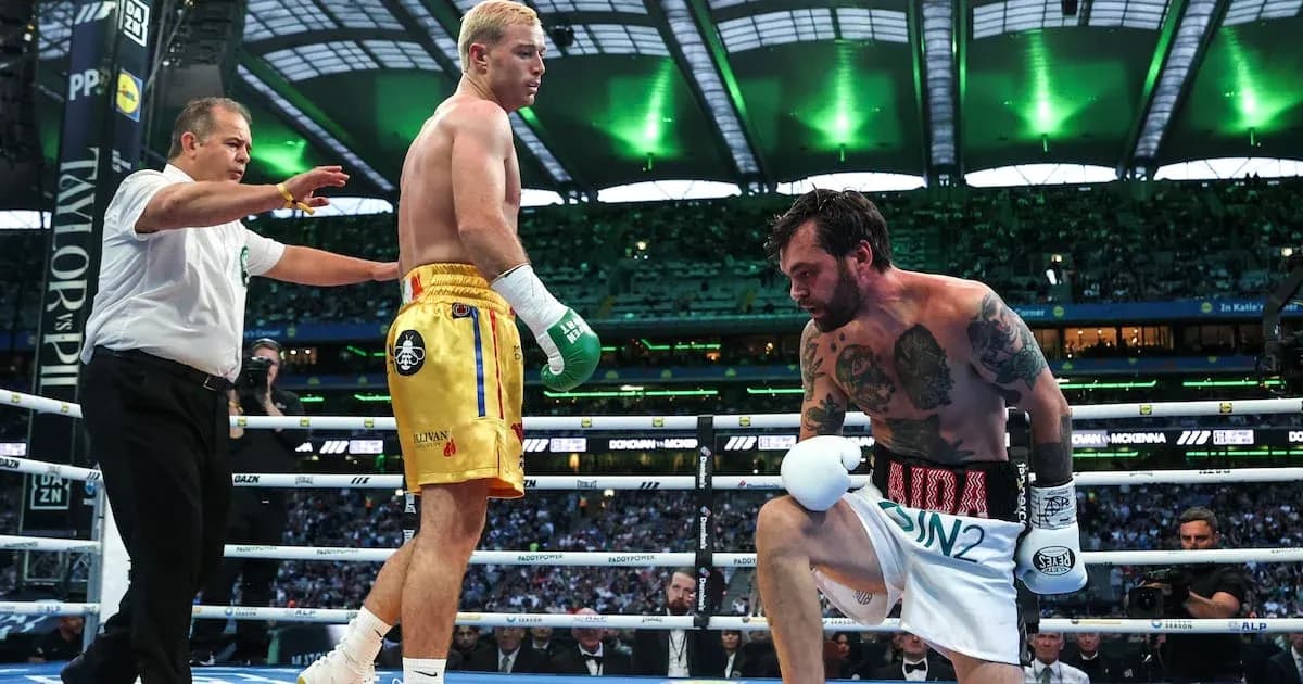 Boxers in the ring during a match with referee Boxers in the ring during a match with referee