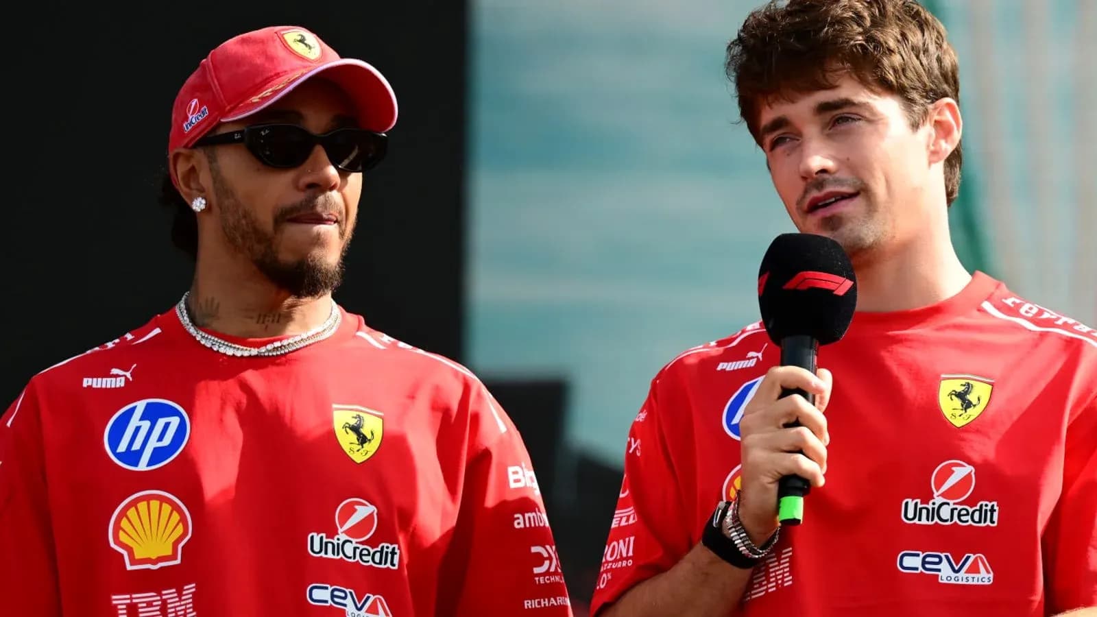 Two Formula 1 drivers speaking at an event Two Formula 1 drivers speaking at an event