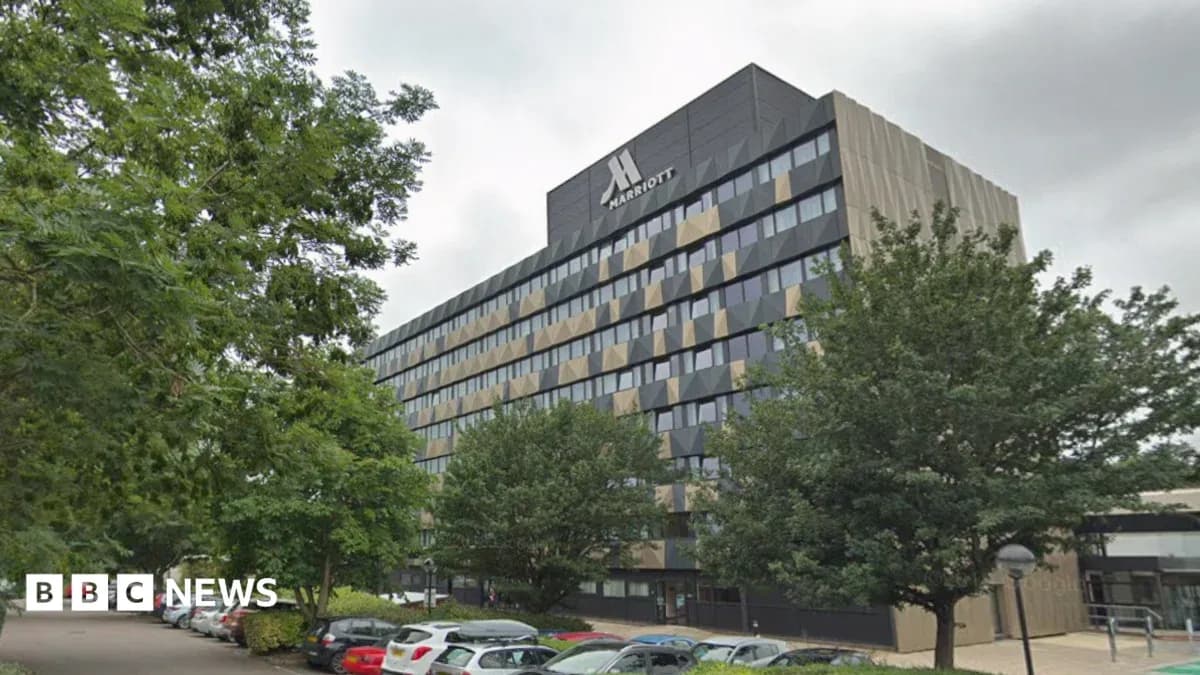 Marriott hotel building surrounded by trees and parking Marriott hotel building surrounded by trees and parking