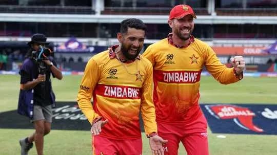 Two Zimbabwean cricketers celebrating on the field Two Zimbabwean cricketers celebrating on the field