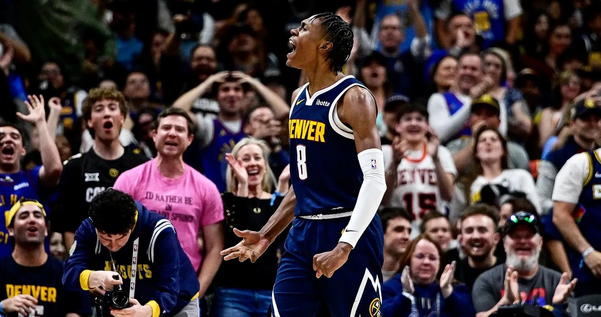 Denver player celebrating in front of cheering crowd Denver player celebrating in front of cheering crowd