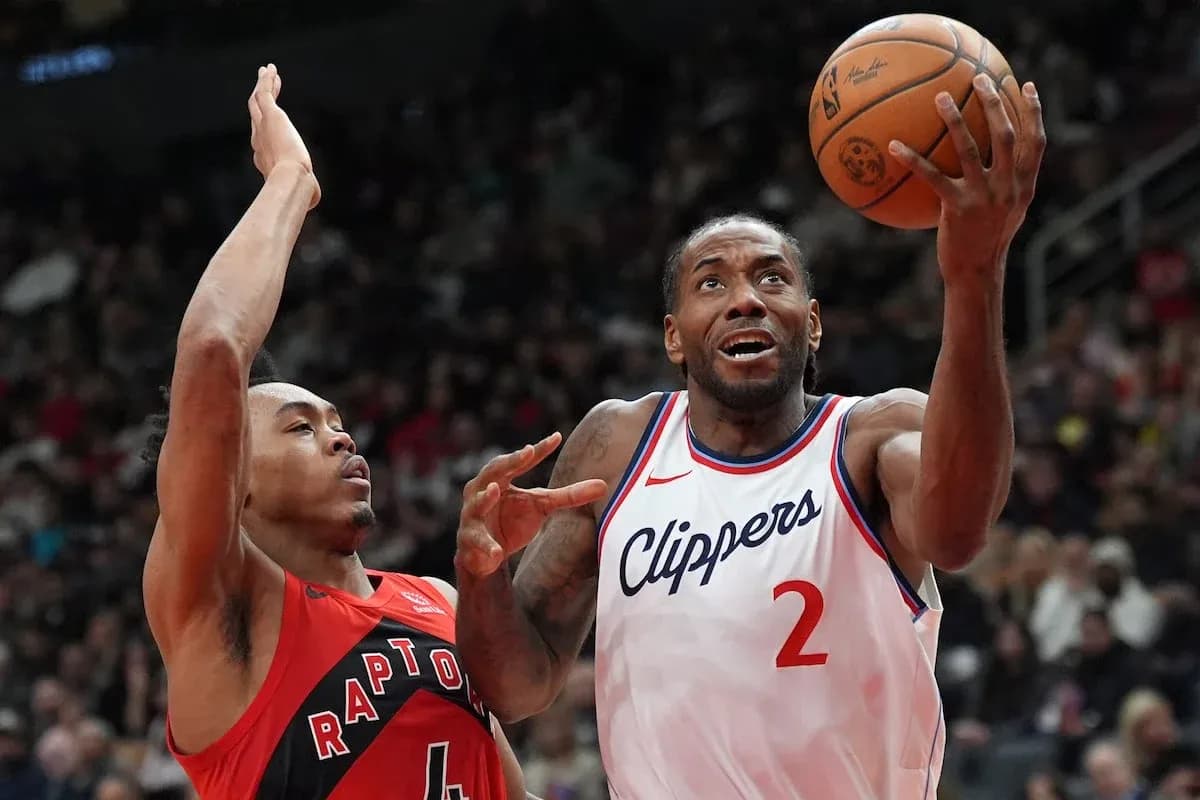 Player shooting the ball while defended during game Player shooting the ball while defended during game