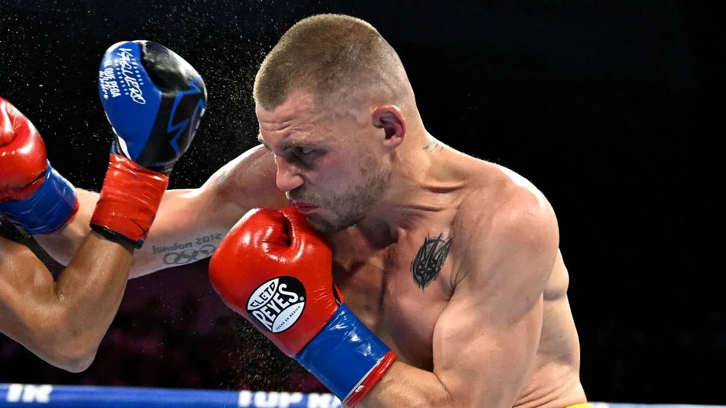 Boxer delivering a punch during a match Boxer delivering a punch during a match