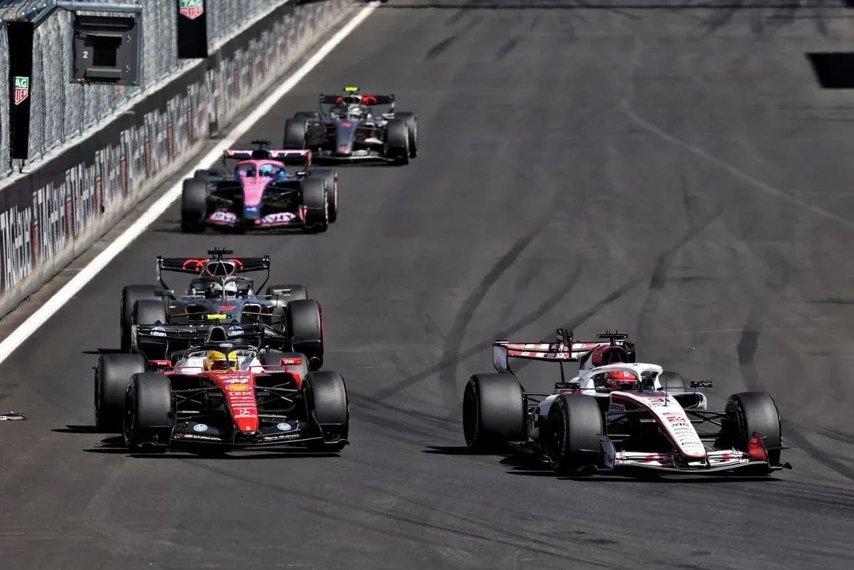 Multiple Formula 1 cars racing on track Multiple Formula 1 cars racing on track