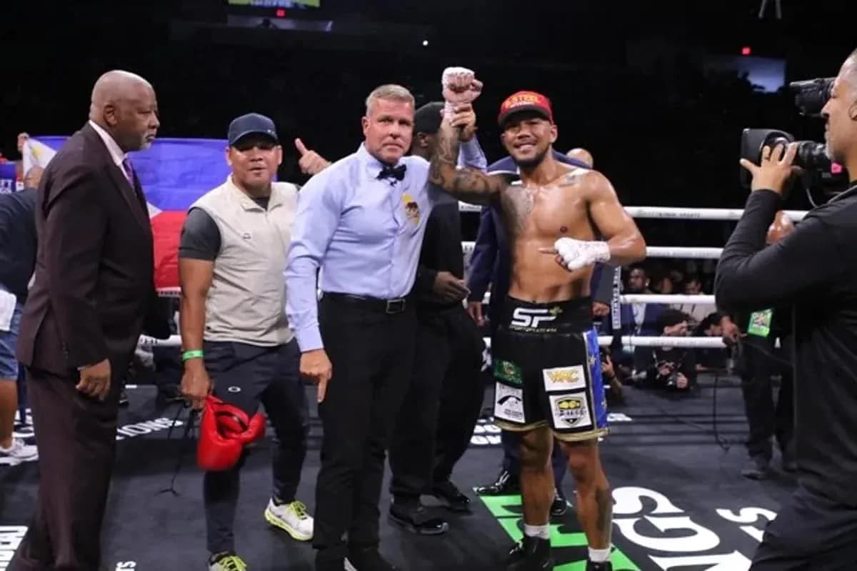 Boxer celebrating victory with referee and team members Boxer celebrating victory with referee and team members