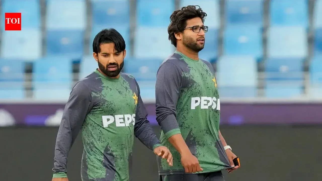 Two Pakistani cricketers walking on the field Two Pakistani cricketers walking on the field