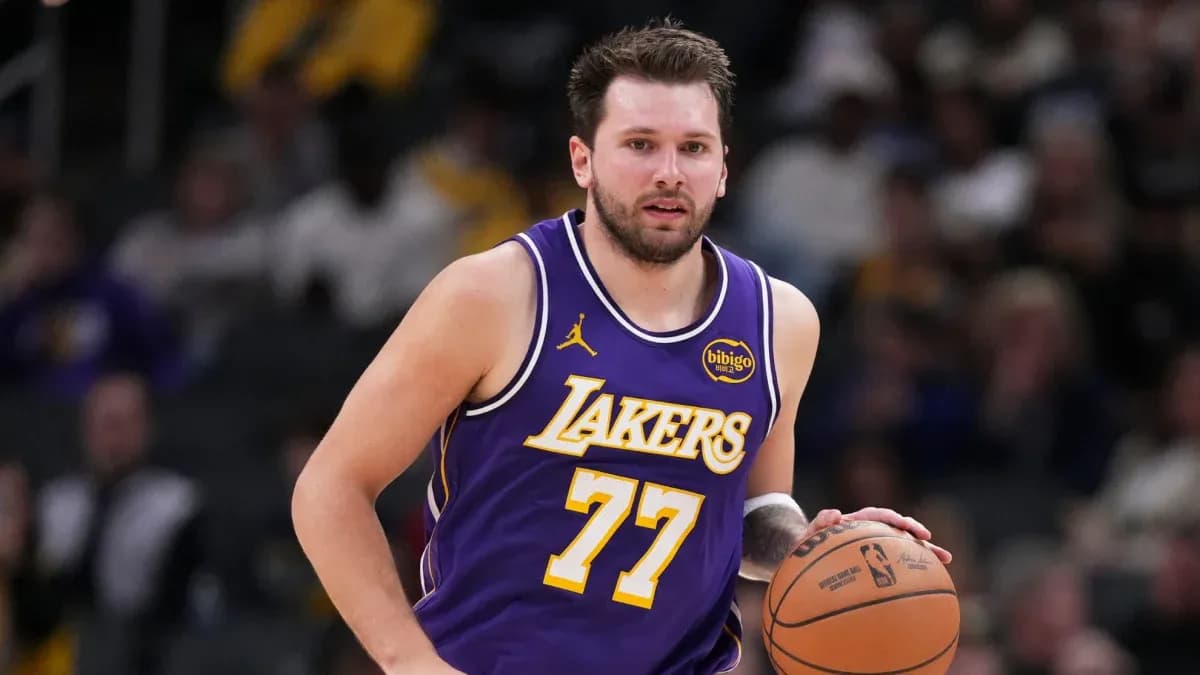 Player dribbling basketball in Lakers jersey Player dribbling basketball in Lakers jersey