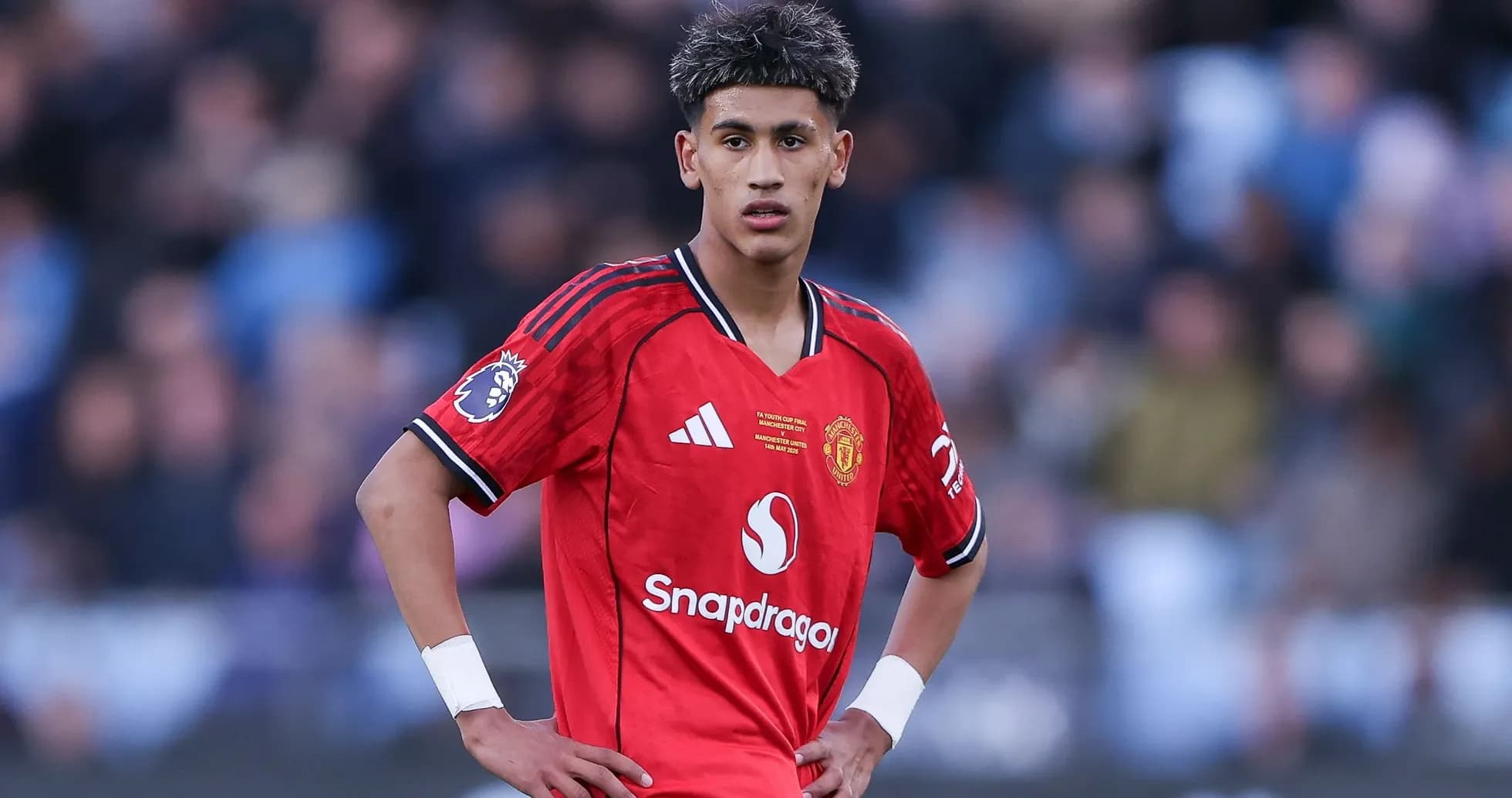 Young player in Manchester United jersey on field Young player in Manchester United jersey on field