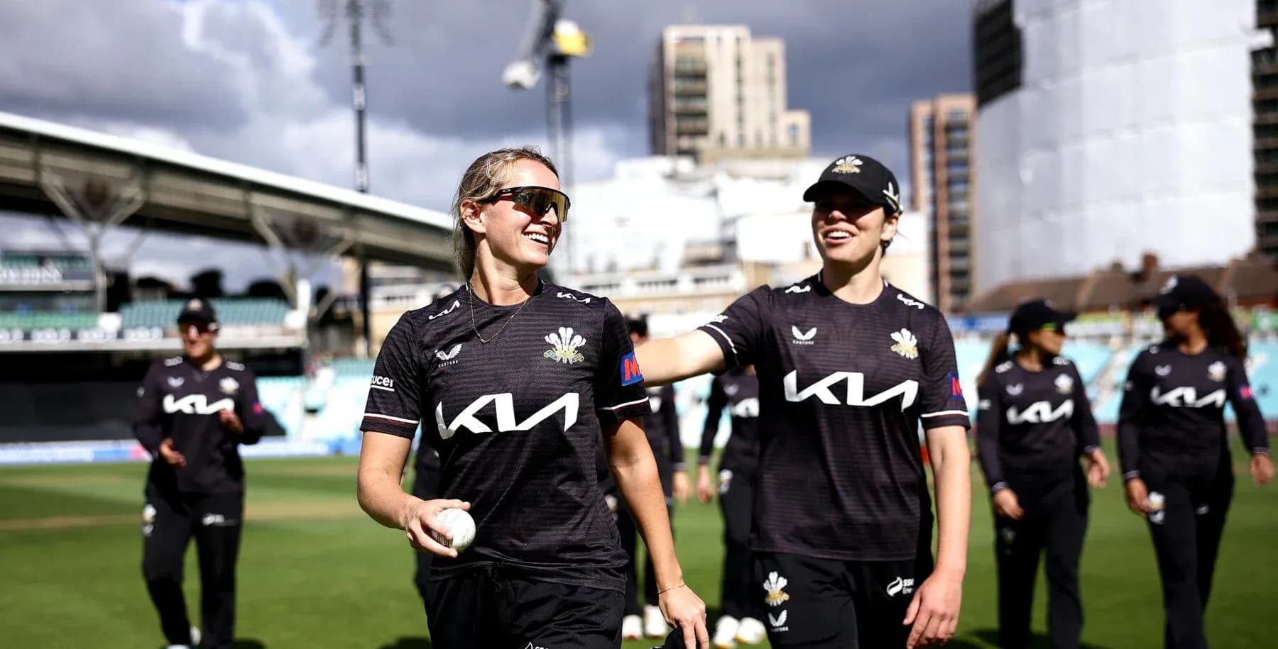 Two cricketers walking off the field after match Two cricketers walking off the field after match