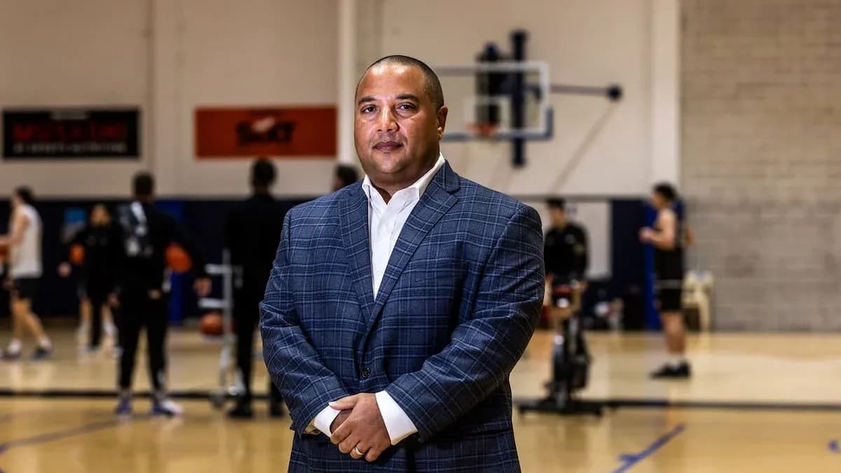 Coach standing on basketball court during practice Coach standing on basketball court during practice