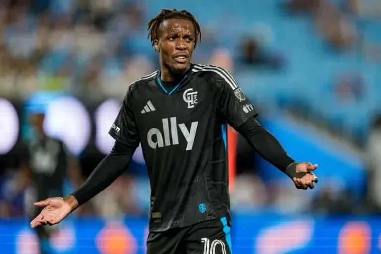 Player gesturing during a match in black uniform Player gesturing during a match in black uniform
