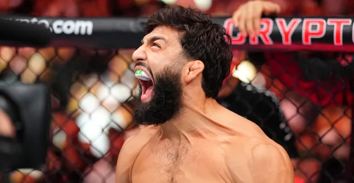 Fighter celebrating with mouthguard in UFC octagon Fighter celebrating with mouthguard in UFC octagon