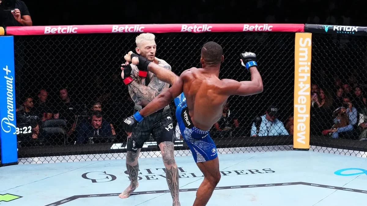 Two fighters competing in an MMA match Two fighters competing in an MMA match