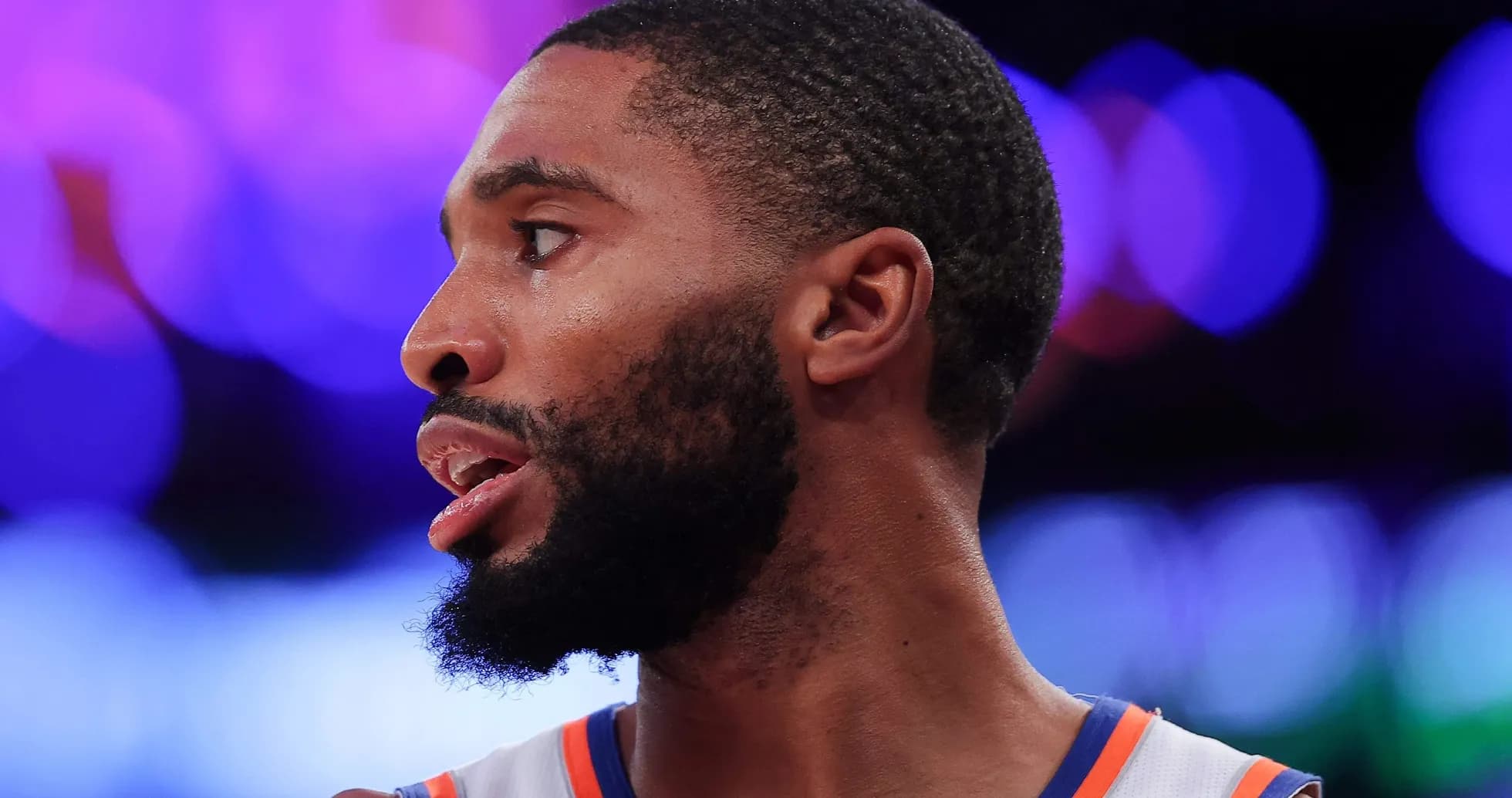 Basketball player in profile during a game Basketball player in profile during a game