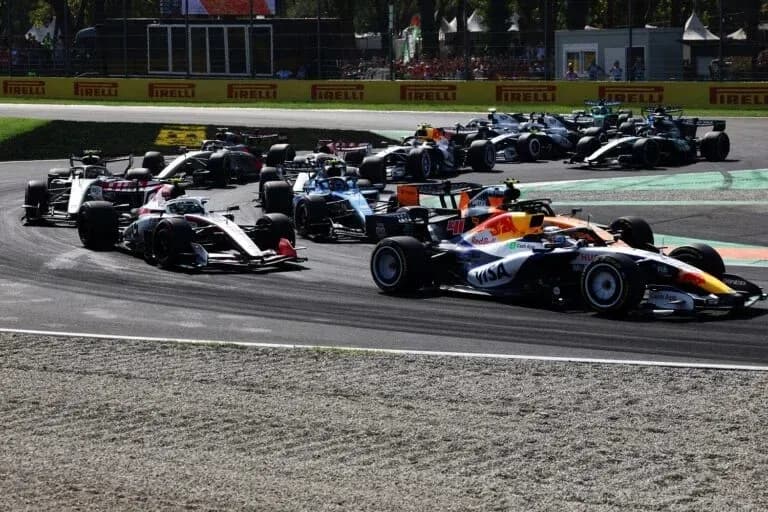 F1 cars racing through a corner on track F1 cars racing through a corner on track