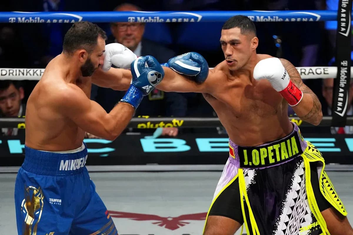 Boxers J. Opetia and M. Mikhael exchanging punches Boxers J. Opetia and M. Mikhael exchanging punches