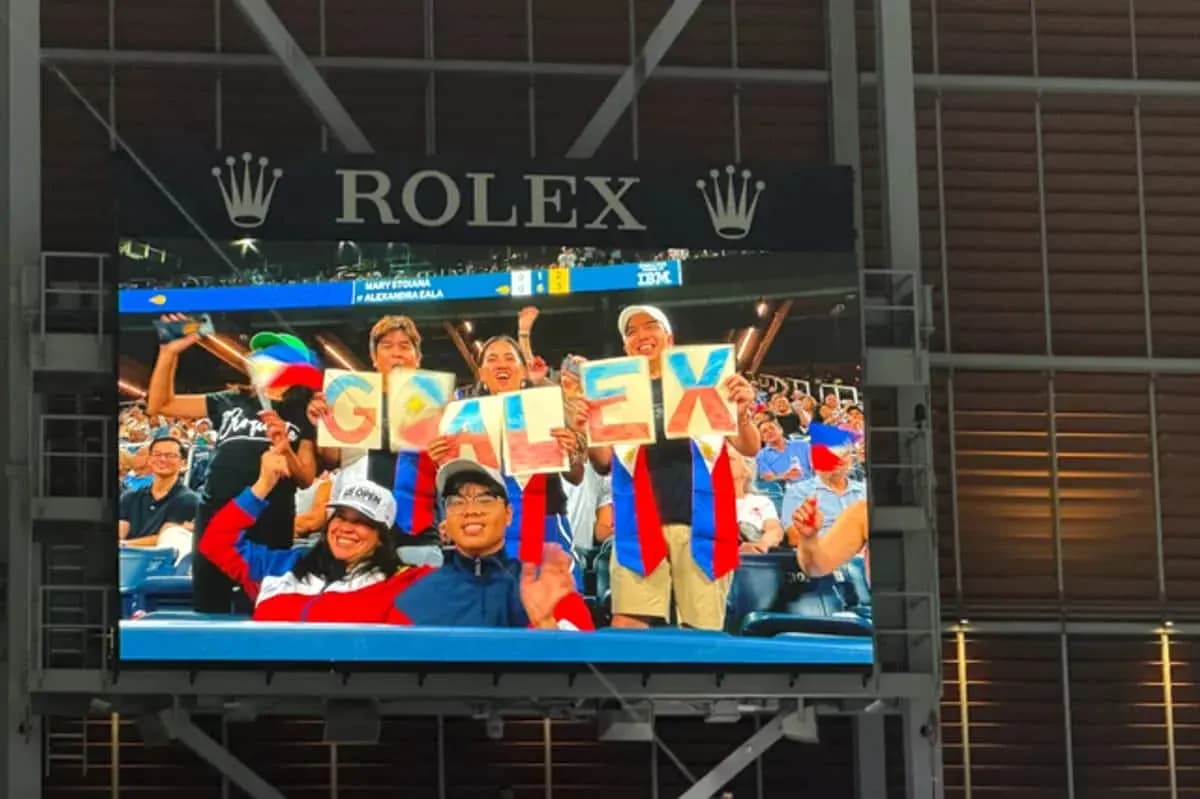 Fans holding signs spelling 'GO ALEX' at match Fans holding signs spelling 'GO ALEX' at match