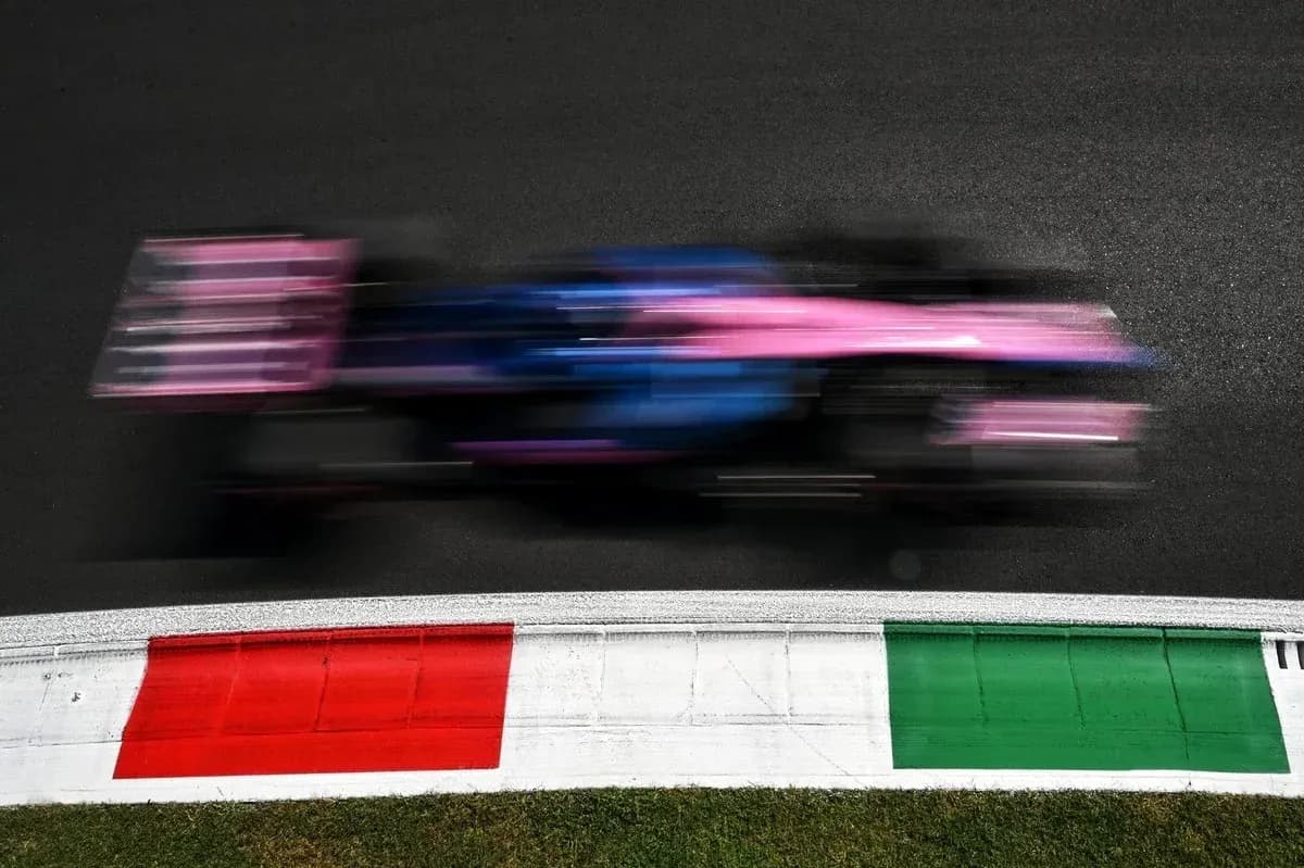 Formula 1 car racing past track curb Formula 1 car racing past track curb
