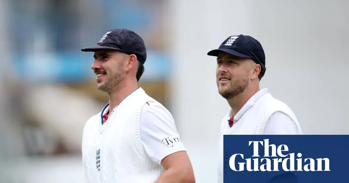 Two cricketers walking on the field in uniforms Two cricketers walking on the field in uniforms