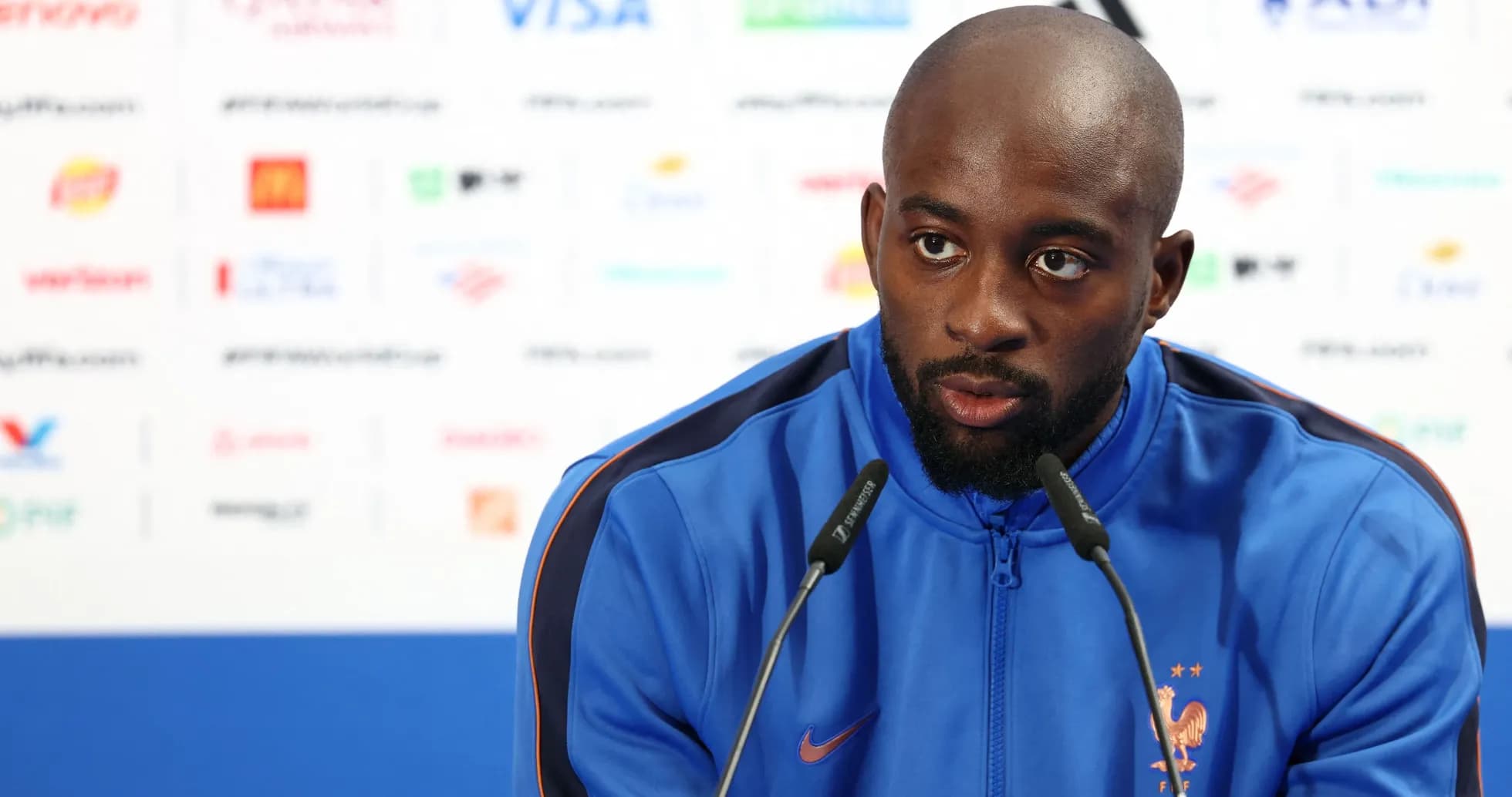 Player speaking at pre-match press conference podium Player speaking at pre-match press conference podium