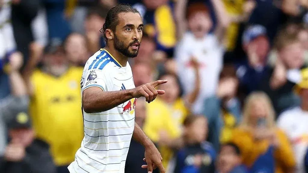 Player celebrating a goal with fans in background Player celebrating a goal with fans in background