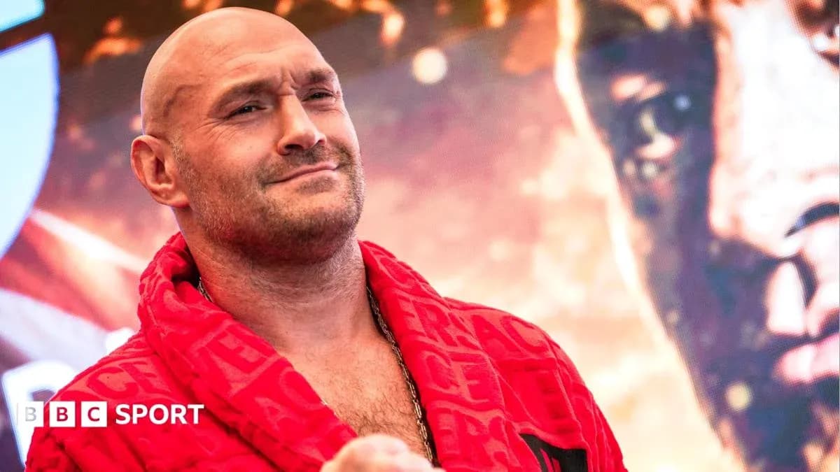 Boxer in red robe posing at promotional event Boxer in red robe posing at promotional event