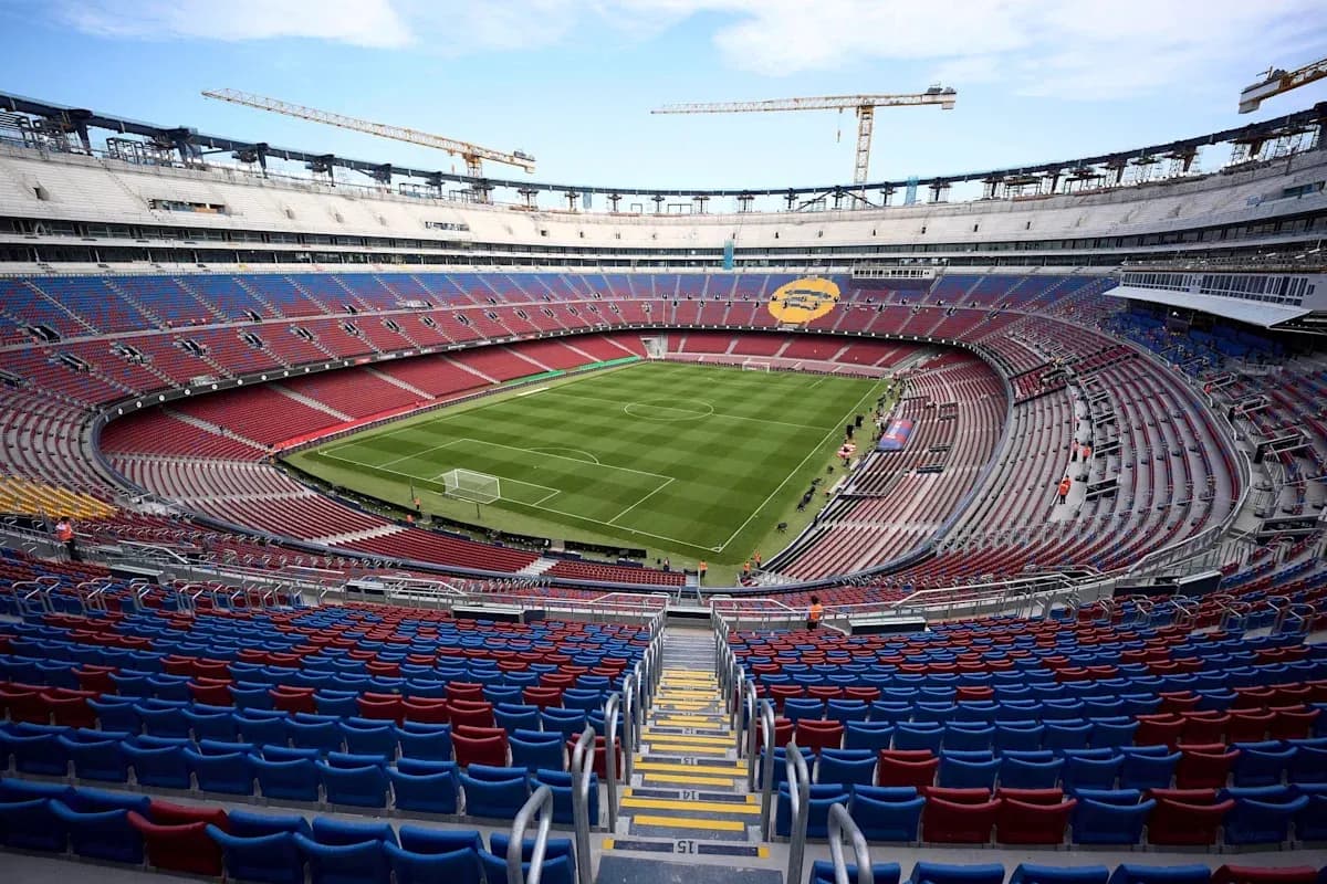 Empty stadium with green football pitch and seating Empty stadium with green football pitch and seating