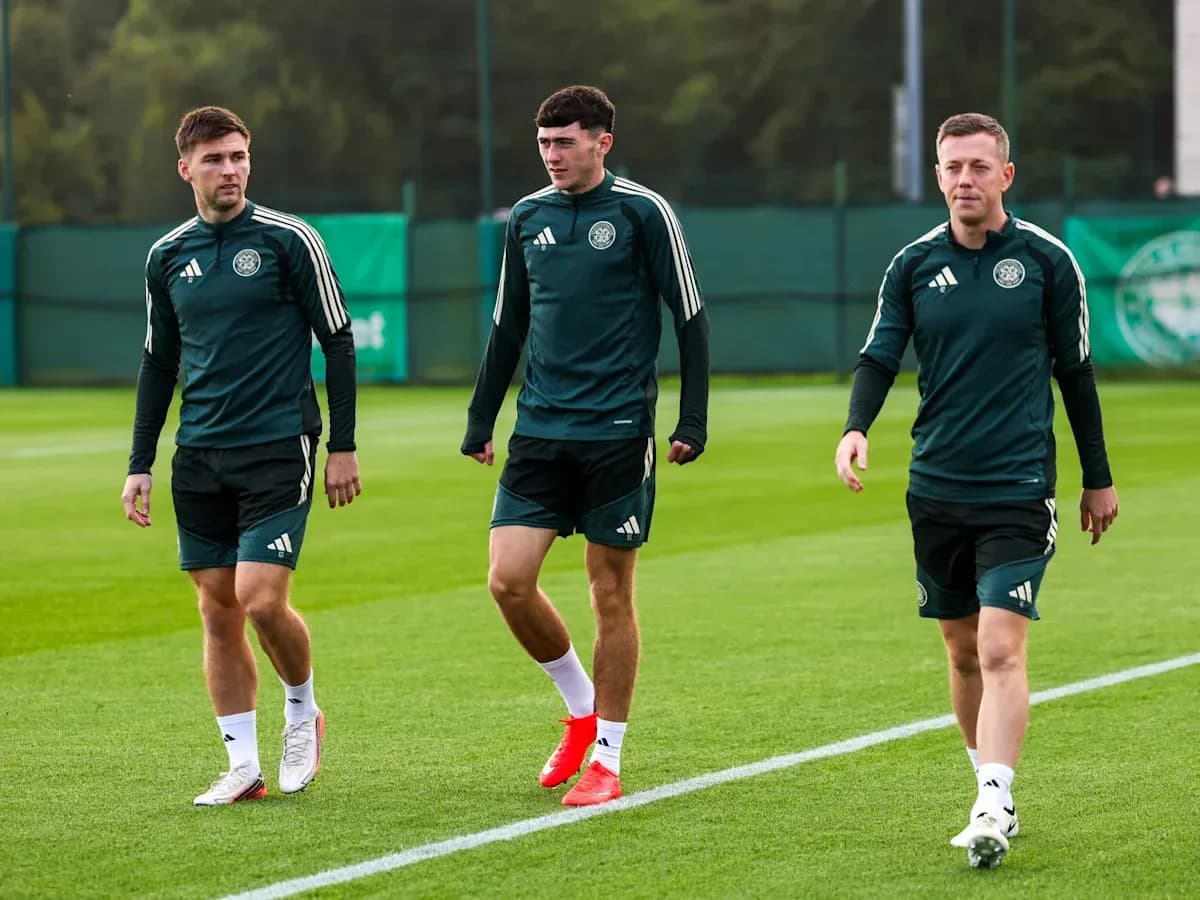 Three players walking on training pitch Three players walking on training pitch