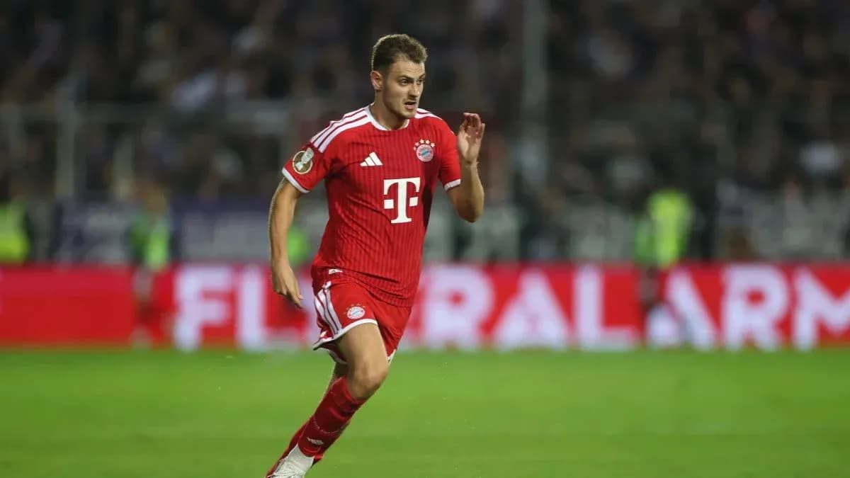 Player in red kit running during match Player in red kit running during match