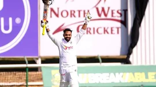 Batsman celebrating century with raised bat Batsman celebrating century with raised bat