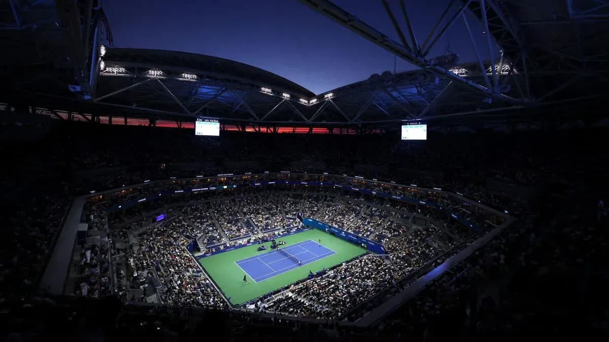 Crowd watching tennis match under stadium lights Crowd watching tennis match under stadium lights