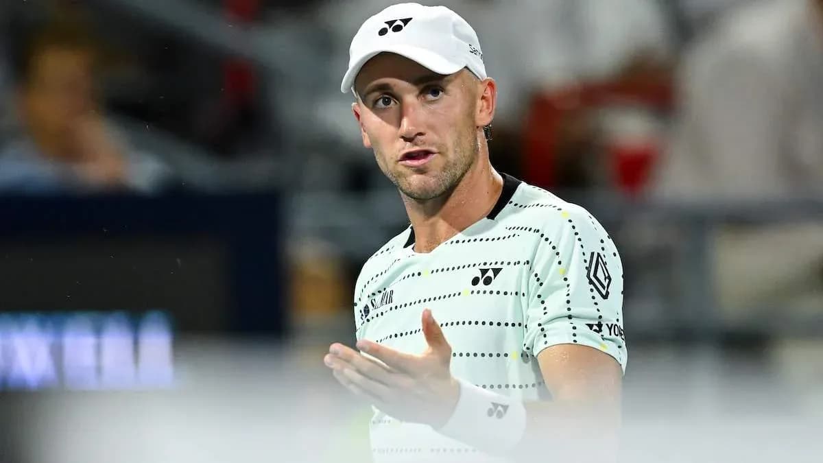Tennis player gesturing during match on court Tennis player gesturing during match on court