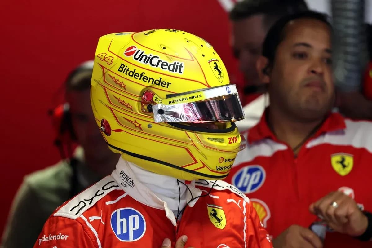 Driver in Ferrari suit and helmet in garage Driver in Ferrari suit and helmet in garage