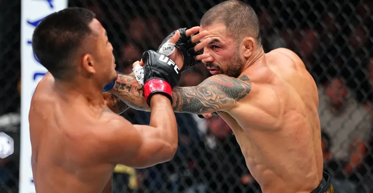 Two fighters exchanging punches in the octagon Two fighters exchanging punches in the octagon
