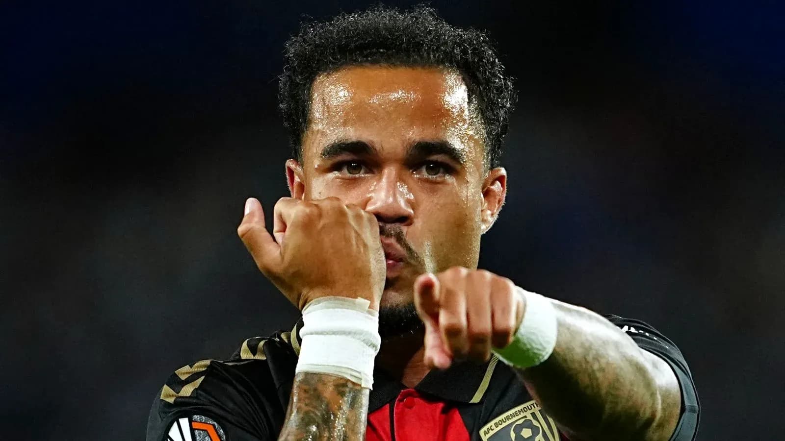 Player celebrating with clenched fists on field Player celebrating with clenched fists on field