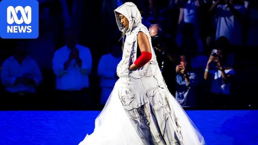 Person walking in unique fashion outfit on stage Person walking in unique fashion outfit on stage