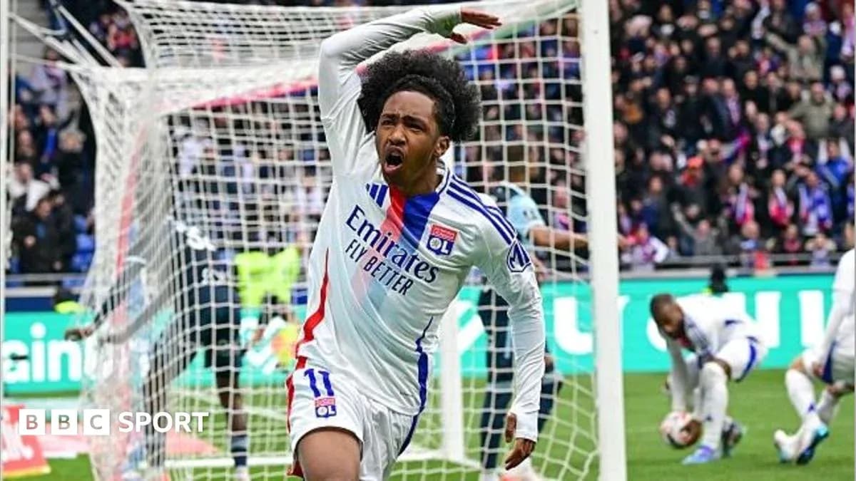 Player celebrating a goal in front of the goalpost Player celebrating a goal in front of the goalpost