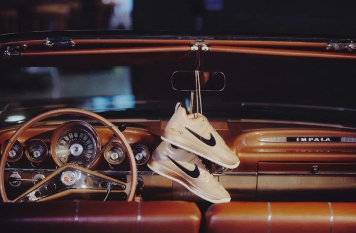 Nike sneakers hanging from vintage car dashboard Nike sneakers hanging from vintage car dashboard