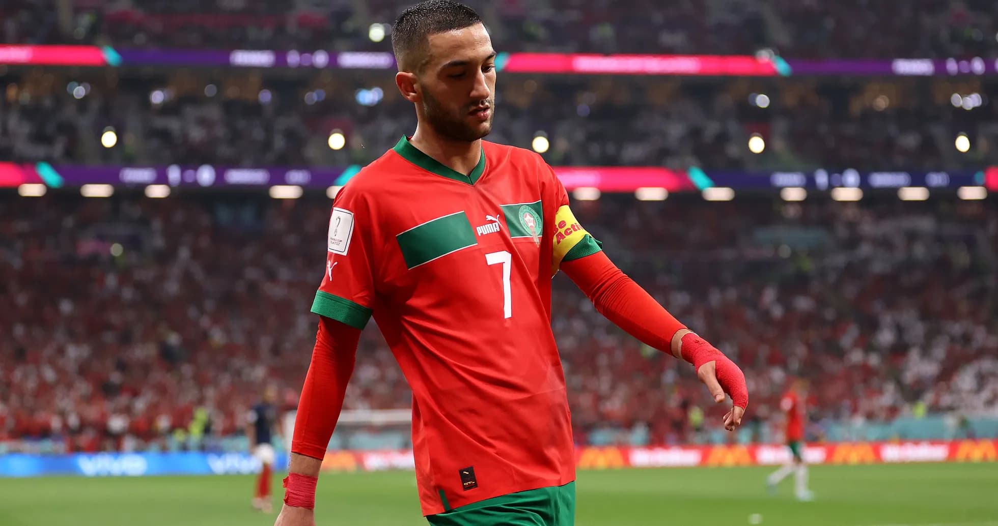 Moroccan player walking on pitch during match Moroccan player walking on pitch during match