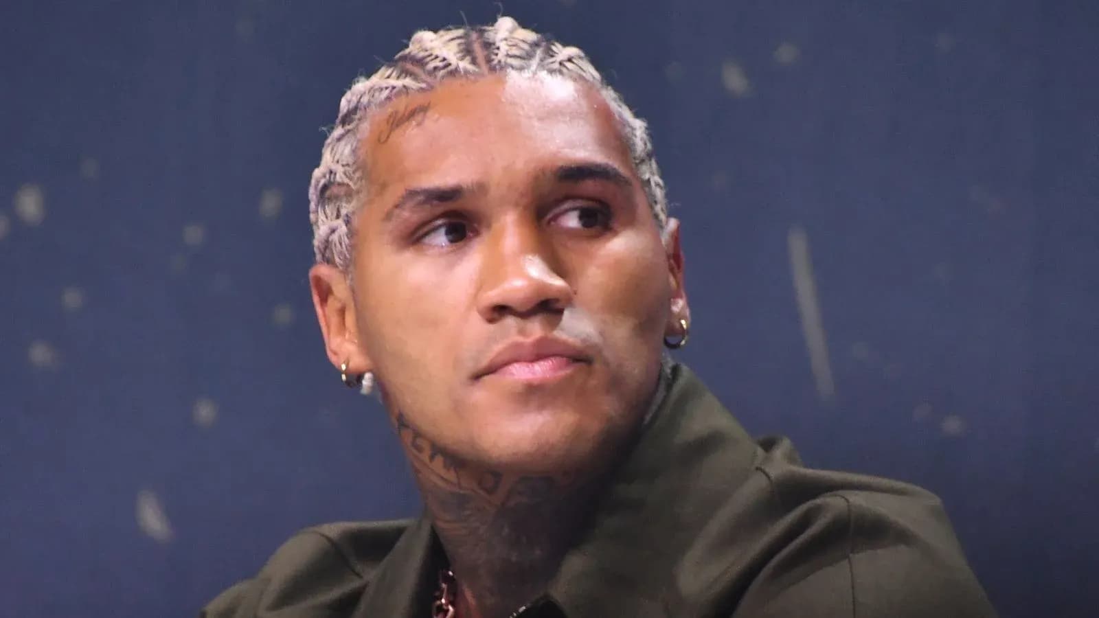 Athlete with braided hair at a press event Athlete with braided hair at a press event