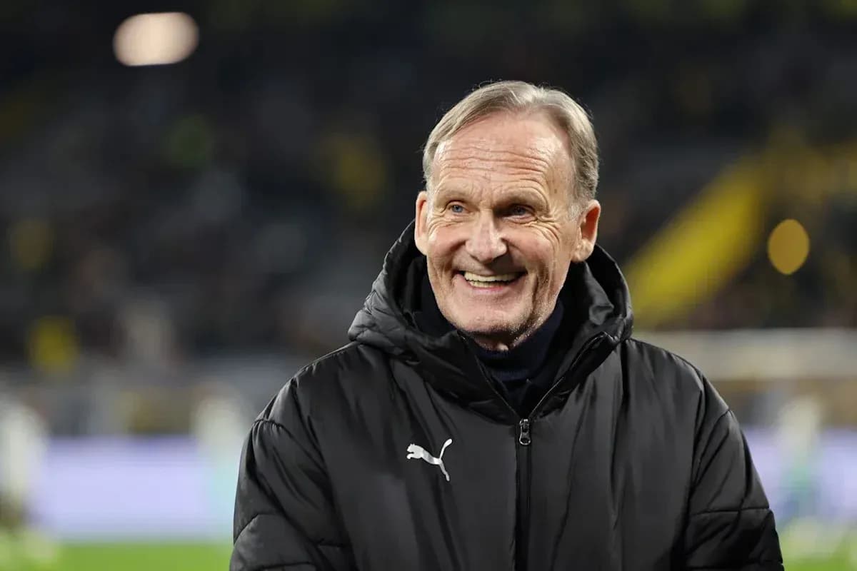Man in black coat smiling at football match Man in black coat smiling at football match