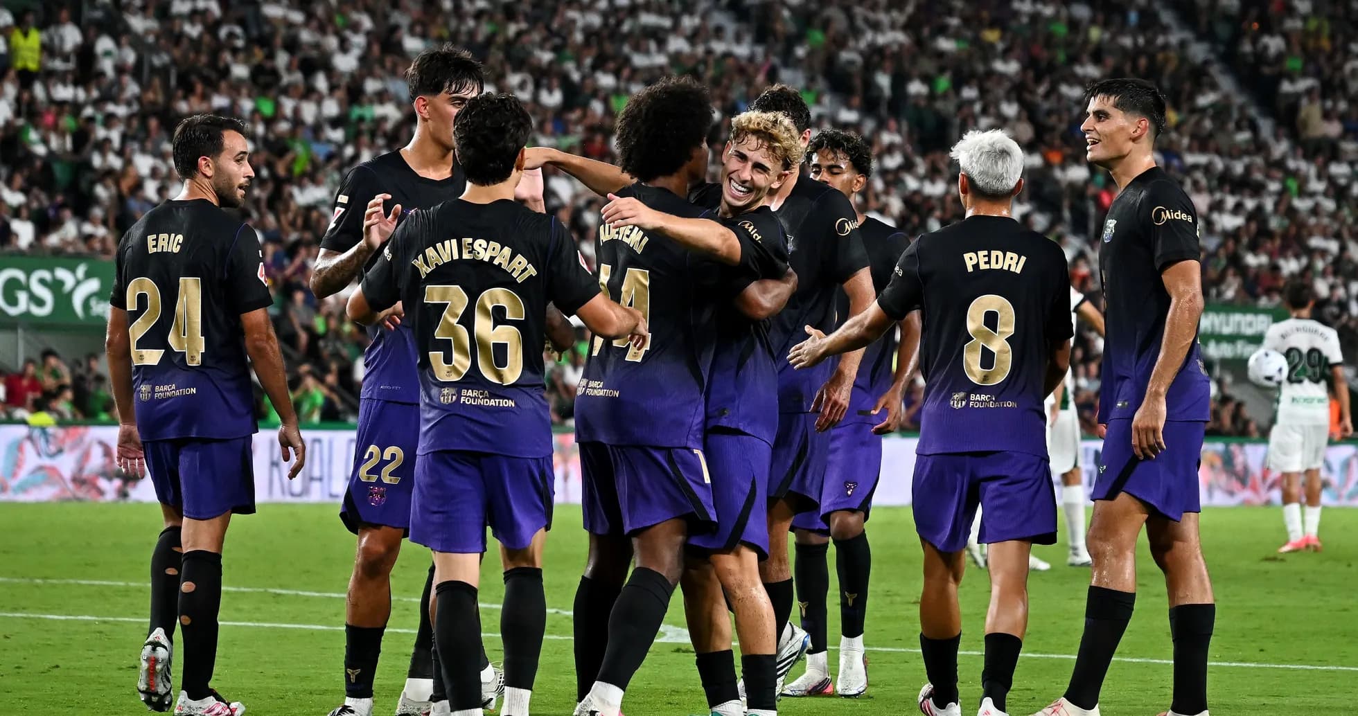Barcelona players celebrating a goal on the field Barcelona players celebrating a goal on the field