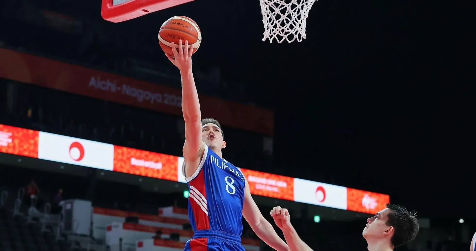 Player scoring a layup during a basketball game Player scoring a layup during a basketball game
