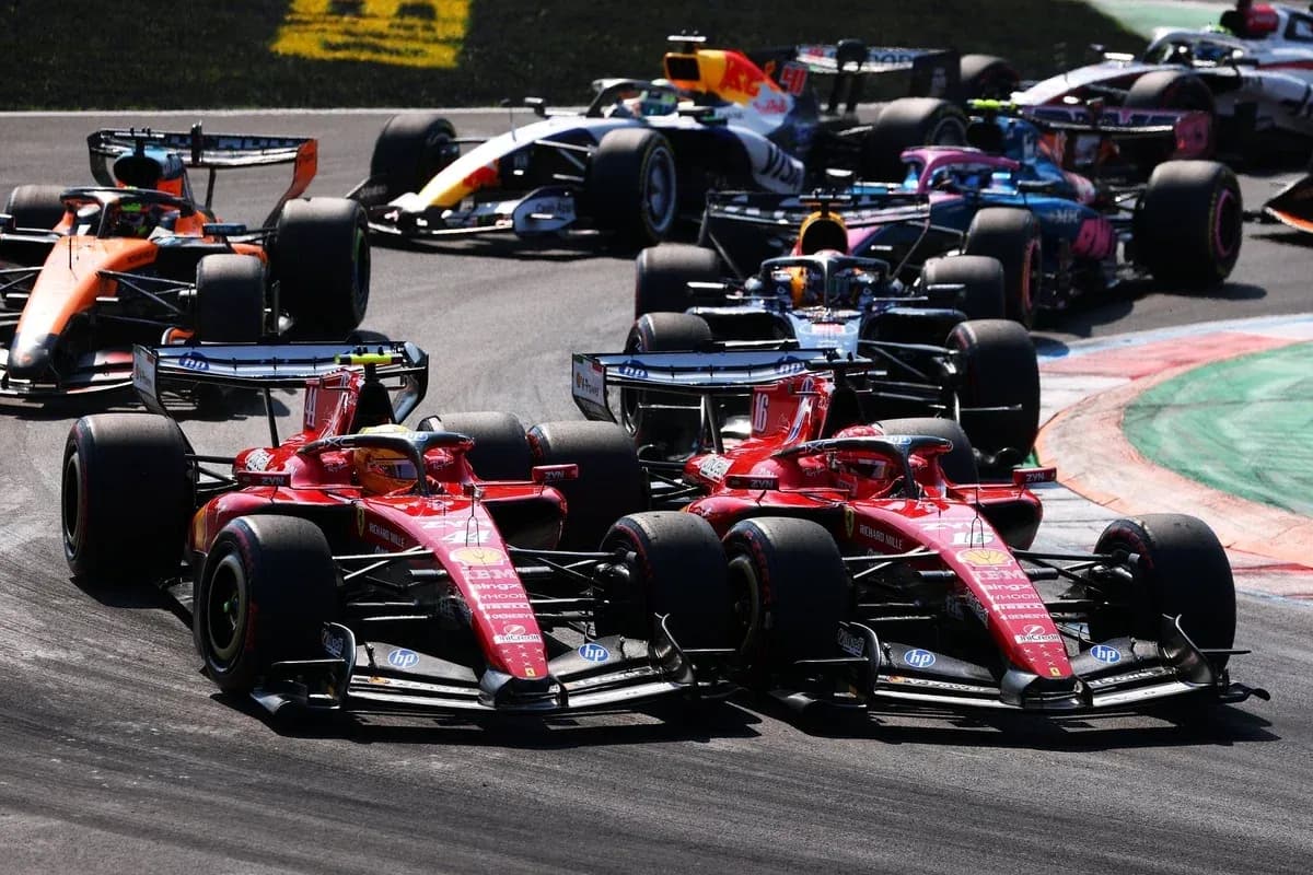 Two Ferrari cars racing closely during a Formula 1 event Two Ferrari cars racing closely during a Formula 1 event