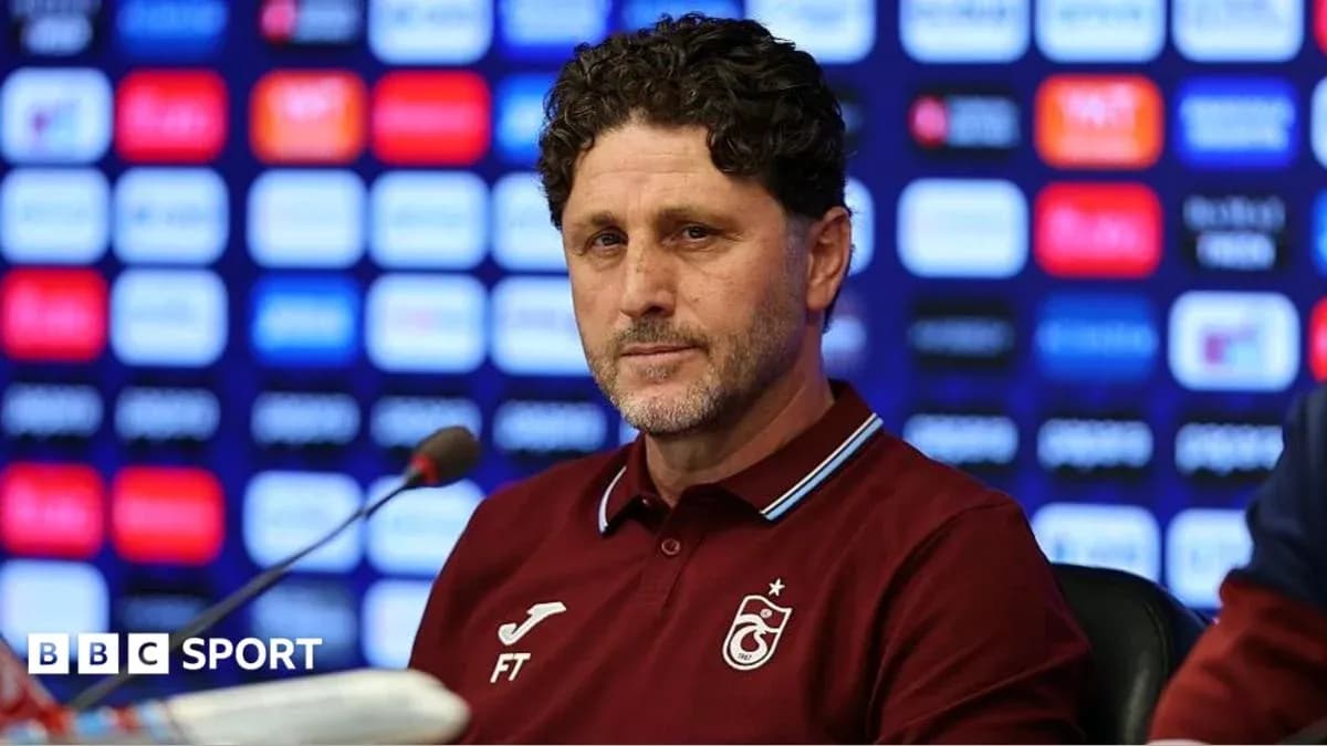 Football manager at press conference podium Football manager at press conference podium